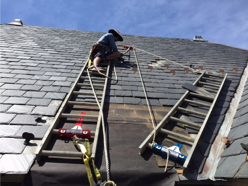 putting a ladder on a roof